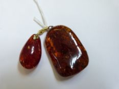 Two amber pendants, largest 4.