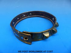 A 19thC brass dog collar with pyramid stud decoration,