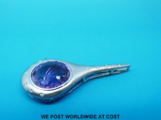 An 18ct white gold pendant in a curved design set with a central amethyst and diamonds to the edge