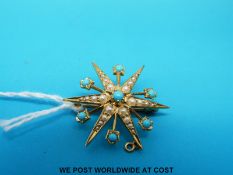 An Edwardian pendant/ brooch marked 15ct gold set with turquoise and seed pearls in a starburst
