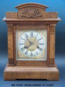 An oak cased mantel clock with two train Wurttemberg movement striking on the quarter with 'ting