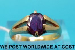 A yellow metal ring marked 18ct set with an oval ruby (size O)