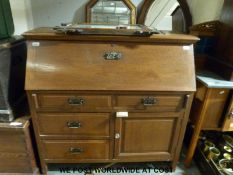 An Art Nouveau bureau with full flap opening to reveal pigeon holes and drawer,