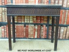 An unusual Georgian mahogany fold over card table with carved floral surround,