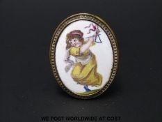 An 18thC English Bilston enamel oval cloak pin or chimney piece knob,
