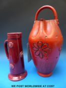 A large red jug with top handle (44cm tall) together with another jug with Art Nouveau style design