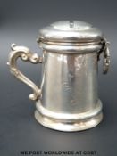 A possibly German white metal money box formed as a tankard, with inscription to front dated 1845,