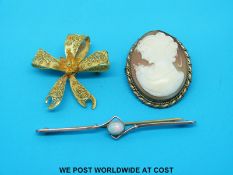 A yellow metal brooch marked 9ct gold set with an opal a silver gilt filigree brooch and a cameo