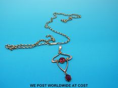 A 9ct gold pendant set with garnets on a 9ct gold belcher chain
