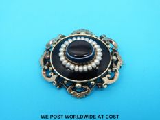 A Victorian mourning brooch set with banded agate, pearls and a foliate border,