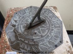 A brass sundial on a Corinthian column together with a terracotta jardiniere