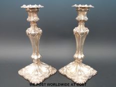 A pair of Victorian hallmarked silver candlesticks of embossed design,