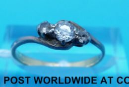 A yellow metal ring marked 18ct set with three cubic zirconia in a twist setting (size M)
