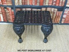 A cast iron footman with pieced top and ball and claw feet (H30 x W48 x D36cm)