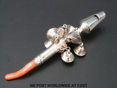 A hallmarked silver coral handled babies rattle, marks indistinguishable,