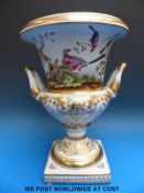 A Continental Campana urn decorated with exotic birds and bearing a Sevres mark (33cm tall)