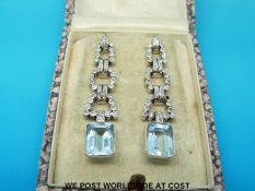 A pair of Art Deco 18ct white gold earrings each set with an emerald cut aquamarine of