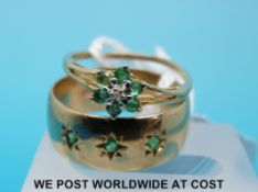 A 9ct gold ring set with emeralds and a yellow metal ring set with diamonds and emeralds in a