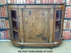 A 19thC inlaid walnut breakfront credenza with two bow glazed cupboards either side of a larger