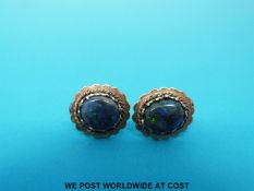 A pair of yellow metal earrings set with opal doublets
