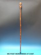 A possibly Chinese carved wood handled walking cane,