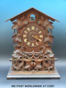 Gordian Hettich Sohn 19th/early 20th century mantel cuckoo clock in carved fenced gallery decorated