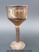 A hallmarked silver goblet with conical bark-effect V, supported on a reeded column,