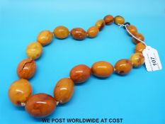 An amber necklace consisting of 19 graduated ovoid beads, the largest 40 x 30mm,