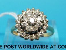 A hallmarked 18ct gold ring set with diamonds in a cluster (size Q)