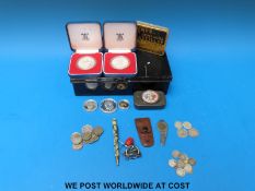A metal cash box containing a USA centenary silver dollar set,