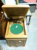 An internal horn gramophone with handle and vintage needle tins in light oak cabinet with USA