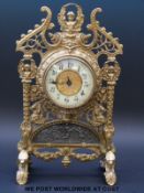 A late 19th or early 20th century pierced brass timepiece with gilt centre to dial in classical