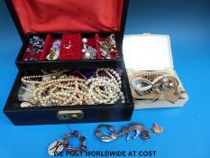 A quantity of costume jewellery to include brooches, watches, ceramic brooches,