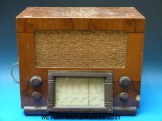A model No.1113 medium and short mave c1950 radio in wooden case with bakelite dial surround.