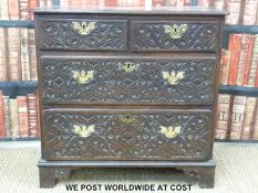 A Georgian carved oak bachelor's chest of two over two graduated drawers,