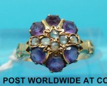 A Victorian ring set with amethysts and rose cut diamonds in a cluster (size I/J)