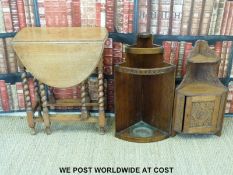An oak drop leaf table and carved oak corner cupboard and an Art Deco umbrella stand