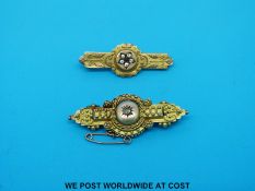 An Edwardian brooch set with a diamond and another Edwardian brooch set with clear stones,