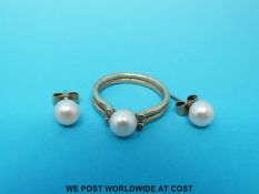 A 14ct gold ring set with a pearl and four diamonds with matching earrings