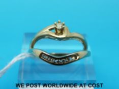 A 9ct gold ring set with a diamond and matching half eternity band set with diamonds (size Q)