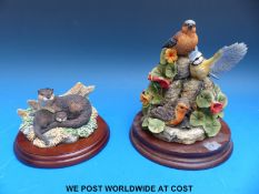 A Border Fine Arts bird group on plinth signed Ayres and a Border Fine Arts Safe Haven otter figure