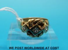 A hallmarked 18ct gold ring set with three diamonds in a knot design setting (London 1916,