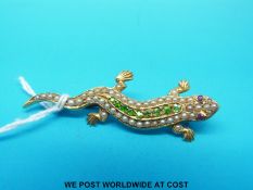 A late Victorian/early Edwardian brooch in the form of a lizard set with peridot,