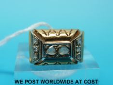 A yellow metal ring marked 18ct set with two rose cut diamonds to the centre and three to either
