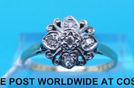 An 18ct gold ring set with diamonds in a platinum setting (size P)