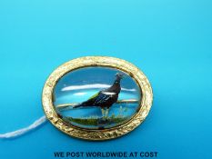 A reverse painted crystal brooch depicting a pheasant marked Mizpah