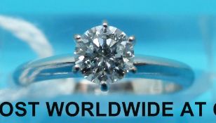 A white metal ring marked 750 set with a round brilliant cut diamond measuring approximately 0.