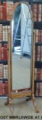 A shaped mahogany cheval mirror (H158cm)