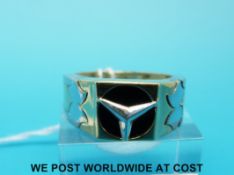 A yellow metal bi-coloured ring with Mercedes symbol to the centre (size V)