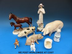 A quantity of ceramic animals and figures including a Royal Doulton dog K34 and pigs